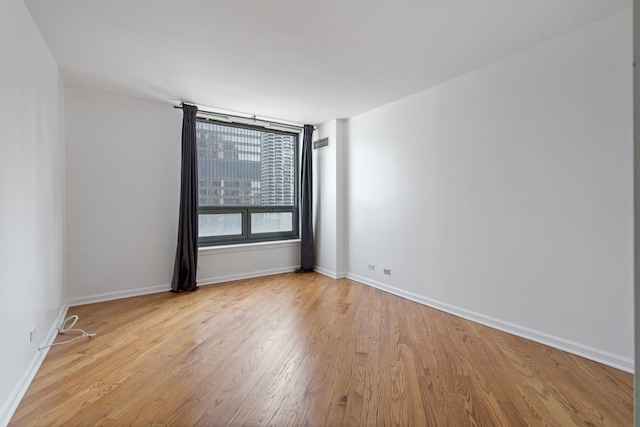 unfurnished room featuring light hardwood / wood-style floors