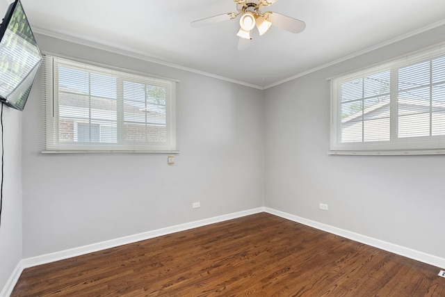 spare room featuring dark hardwood / wood-style floors, ceiling fan, and crown molding