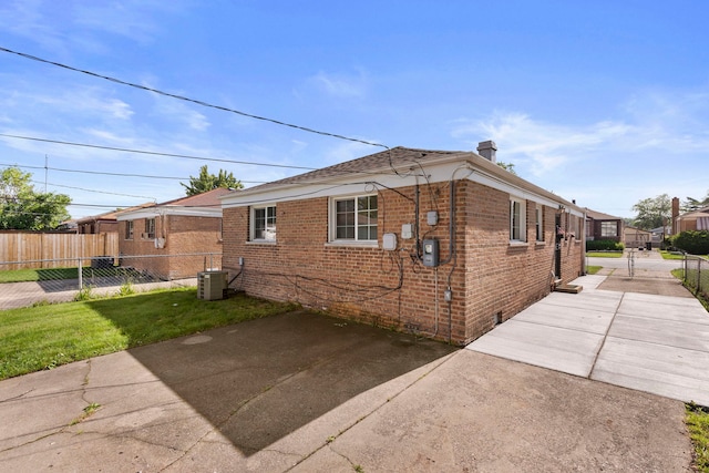 view of property exterior featuring a lawn and central air condition unit