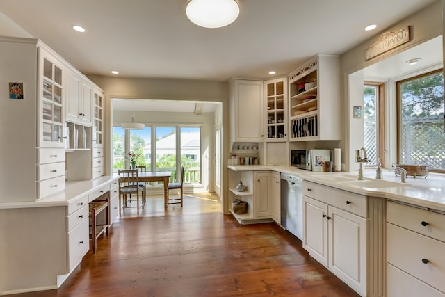 kitchen with dark hardwood / wood-style flooring, stainless steel appliances, and white cabinets