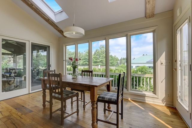 sunroom with vaulted ceiling with skylight