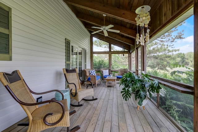 sunroom / solarium featuring vaulted ceiling with beams, wood ceiling, and ceiling fan