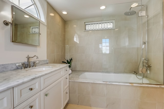 bathroom featuring enclosed tub / shower combo and vanity