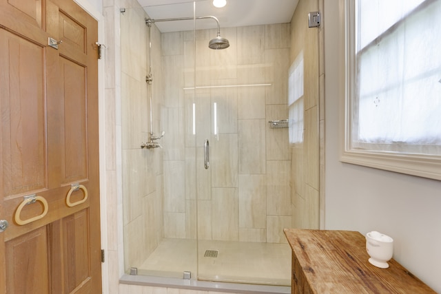 bathroom with a shower with door