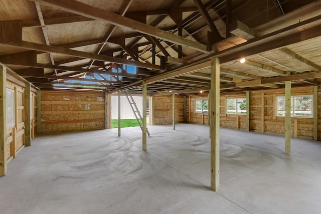 misc room with concrete floors and lofted ceiling