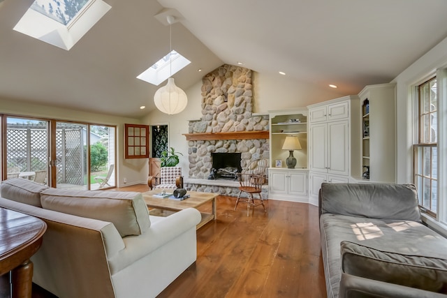 living room featuring a skylight, a fireplace, high vaulted ceiling, and hardwood / wood-style flooring