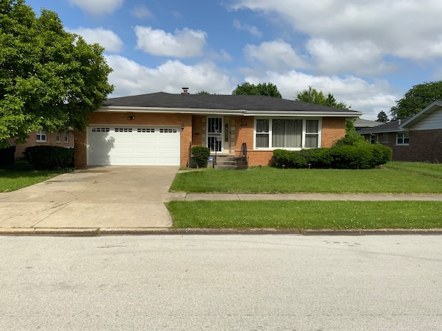 single story home featuring a garage and a front lawn