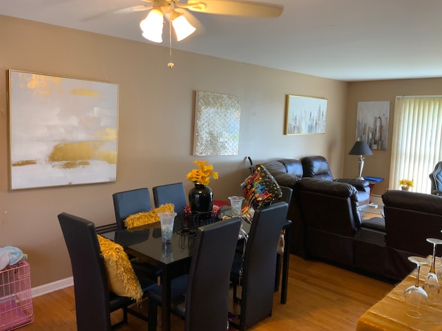 dining room with ceiling fan and hardwood / wood-style flooring