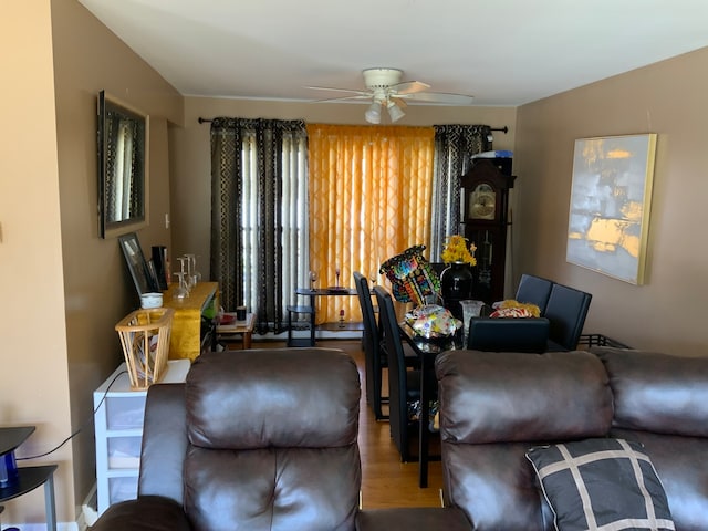 living room featuring wood-type flooring and ceiling fan