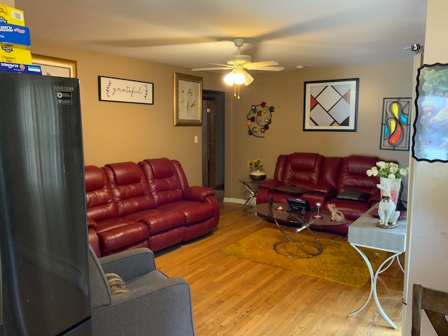 living room with wood-type flooring and ceiling fan