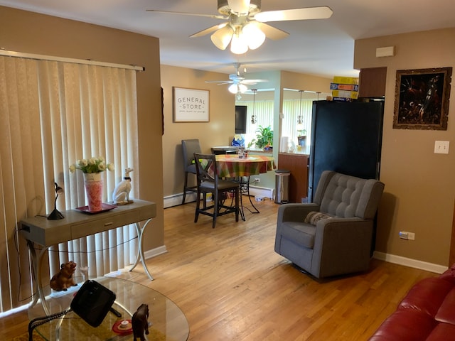 living room featuring hardwood / wood-style flooring, a baseboard radiator, and ceiling fan