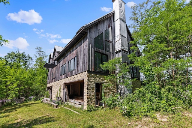 view of side of home featuring a lawn