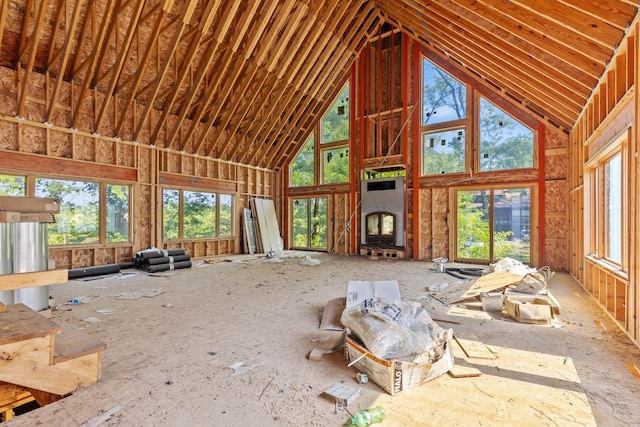 miscellaneous room with high vaulted ceiling and a healthy amount of sunlight