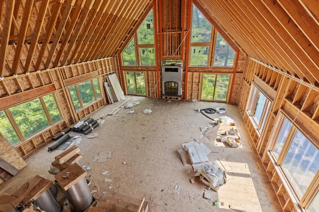 unfurnished living room featuring plenty of natural light and high vaulted ceiling