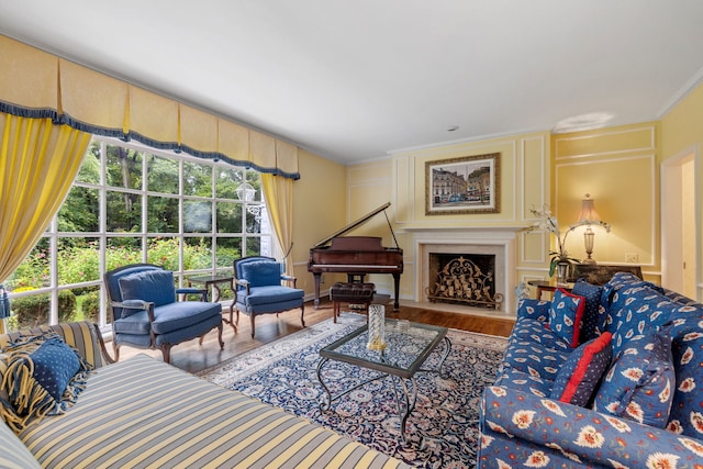 living room featuring crown molding, a fireplace, and wood finished floors