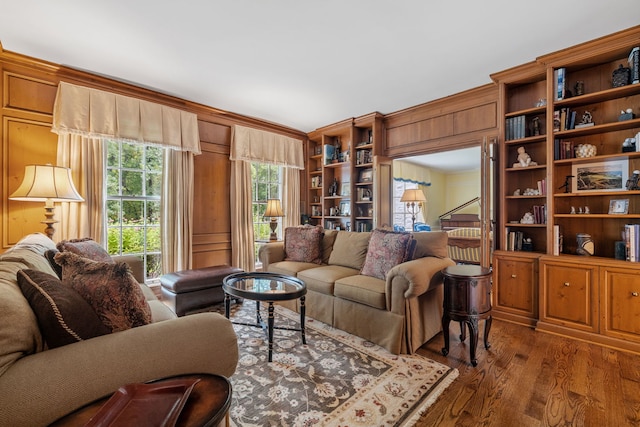 living area with wood walls and wood finished floors