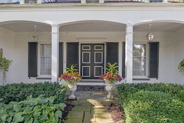 view of exterior entry with covered porch