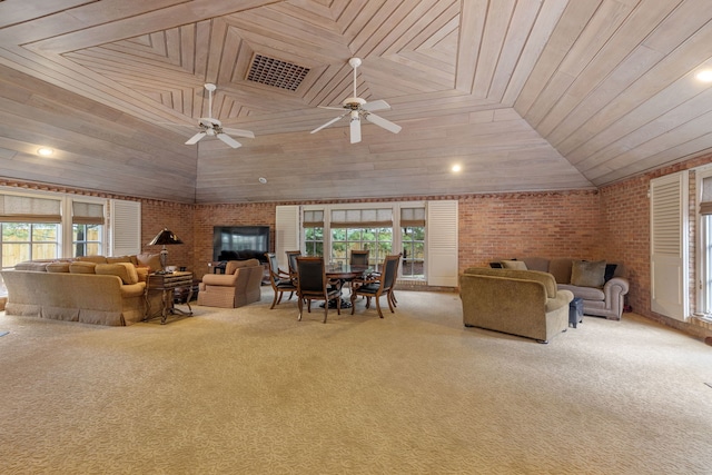 carpeted living area featuring a ceiling fan, lofted ceiling, and brick wall