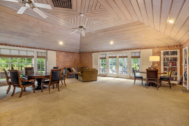 carpeted dining area with a ceiling fan, lofted ceiling, wooden ceiling, and french doors