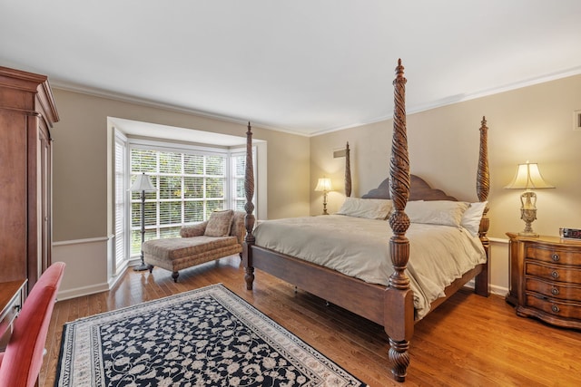 bedroom with ornamental molding and wood-type flooring