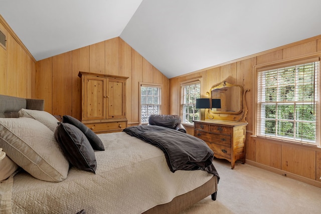 carpeted bedroom with wooden walls and vaulted ceiling