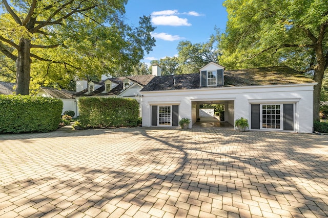 new england style home with a chimney