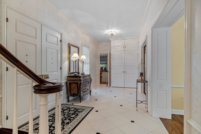 tiled entrance foyer with crown molding