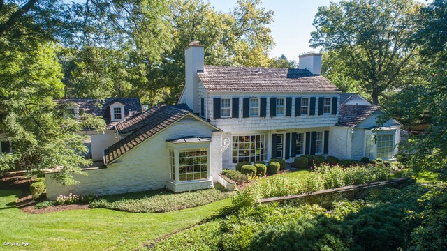 rear view of property featuring a yard