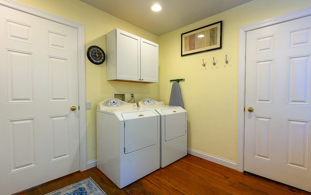 washroom with cabinets, independent washer and dryer, and dark hardwood / wood-style flooring
