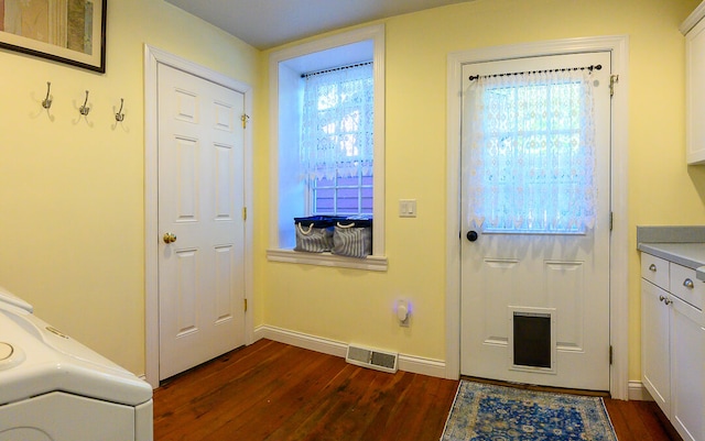 doorway featuring washer / clothes dryer, dark hardwood / wood-style flooring, and plenty of natural light