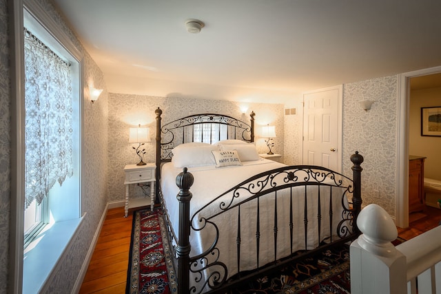 bedroom with hardwood / wood-style floors