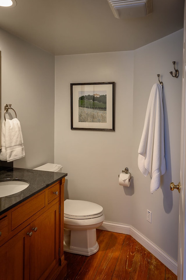 bathroom featuring hardwood / wood-style floors, vanity, and toilet