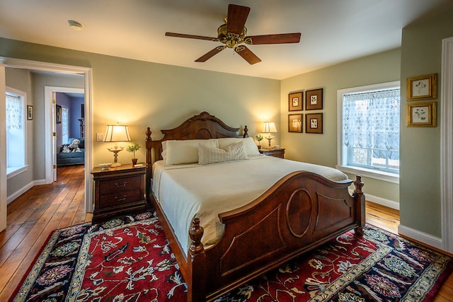 bedroom with wood-type flooring and ceiling fan