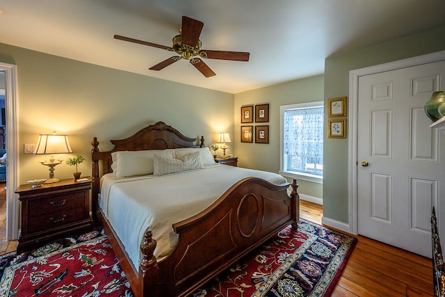 bedroom featuring hardwood / wood-style floors and ceiling fan