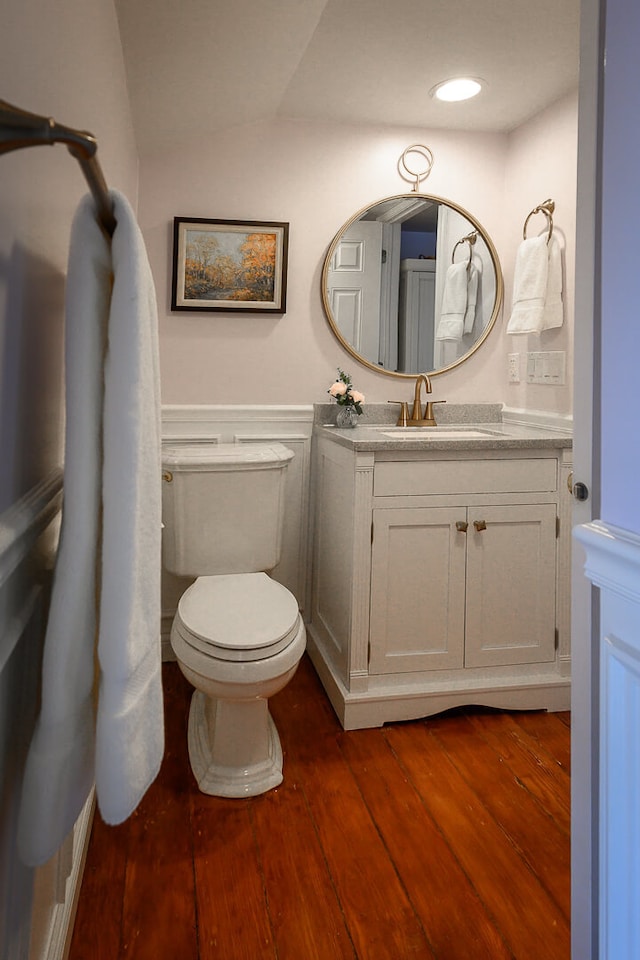 bathroom with vanity, hardwood / wood-style flooring, and toilet