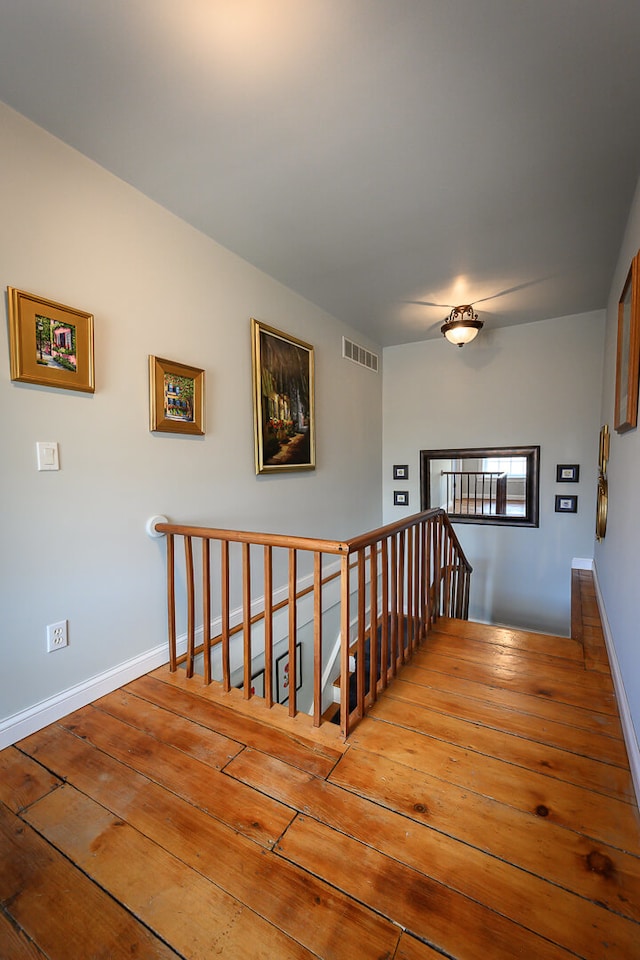 staircase featuring hardwood / wood-style flooring