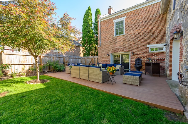rear view of property with outdoor lounge area, a deck, and a lawn
