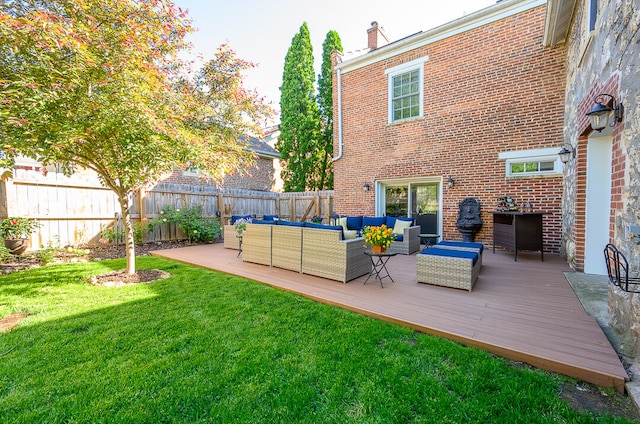 back of property featuring outdoor lounge area, a yard, and a deck