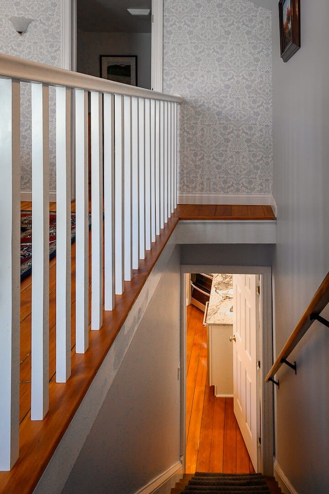 stairway featuring hardwood / wood-style flooring