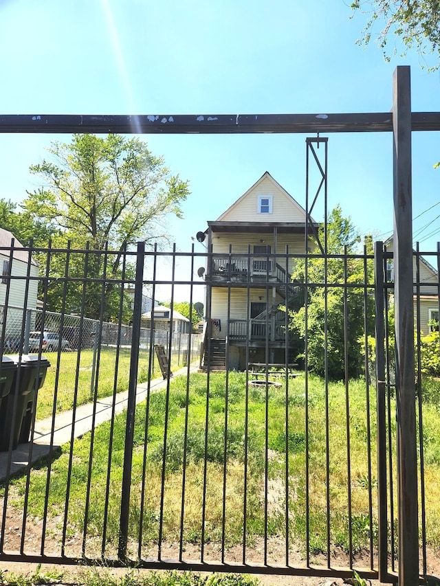 view of gate with a yard