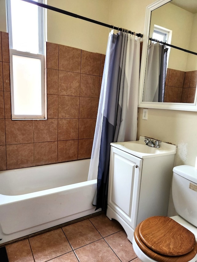 full bathroom with tile patterned floors, a healthy amount of sunlight, shower / tub combo, and toilet