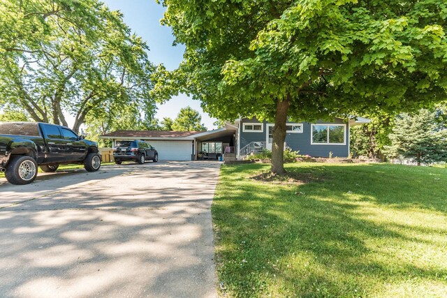 view of front of home with a front yard and a carport