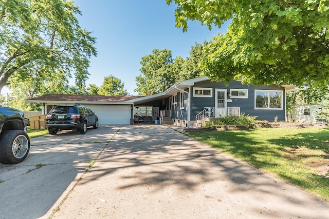 view of front of home featuring a garage, a carport, and a front yard