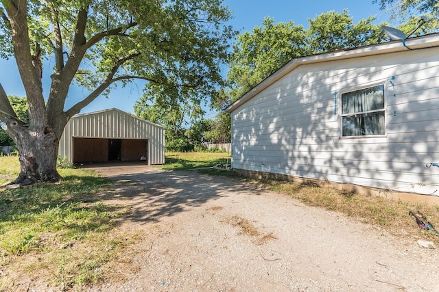 view of side of home with a garage and an outdoor structure