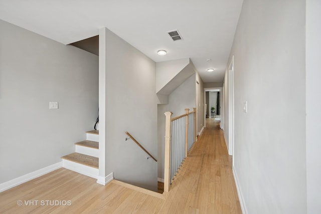 2550 W Thomas St, Chicago, IL 60622 - corridor with baseboards, visible vents, light wood finished floors, and an upstairs landing