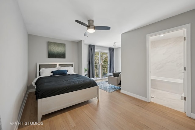 2550 W Thomas St, Chicago, IL 60622 - bedroom with baseboards, ensuite bath, wood finished floors, and ceiling fan