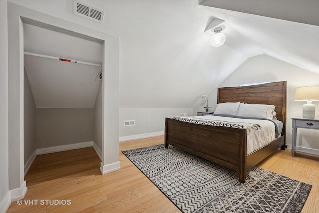 2550 W Thomas St, Chicago, IL 60622 - bedroom featuring baseboards, lofted ceiling, wood finished floors, and visible vents
