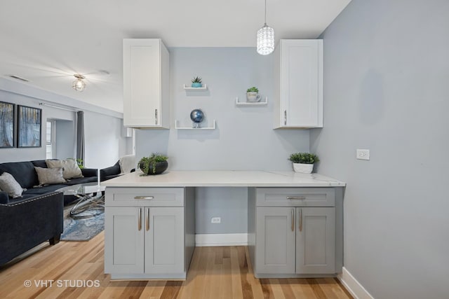 2550 W Thomas St, Chicago, IL 60622 - kitchen with gray cabinets, baseboards, open floor plan, light wood-type flooring, and visible vents