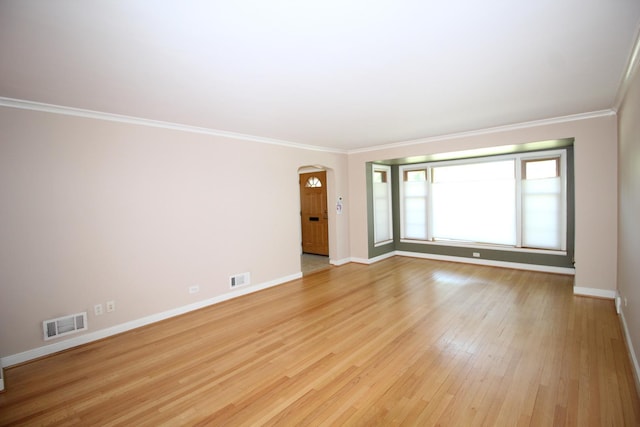 3415 W Maple St, Evergreen Park, IL 60805 - spare room with arched walkways, crown molding, and light wood-style floors