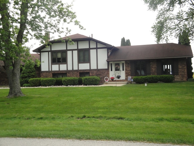 tudor-style house featuring a front lawn